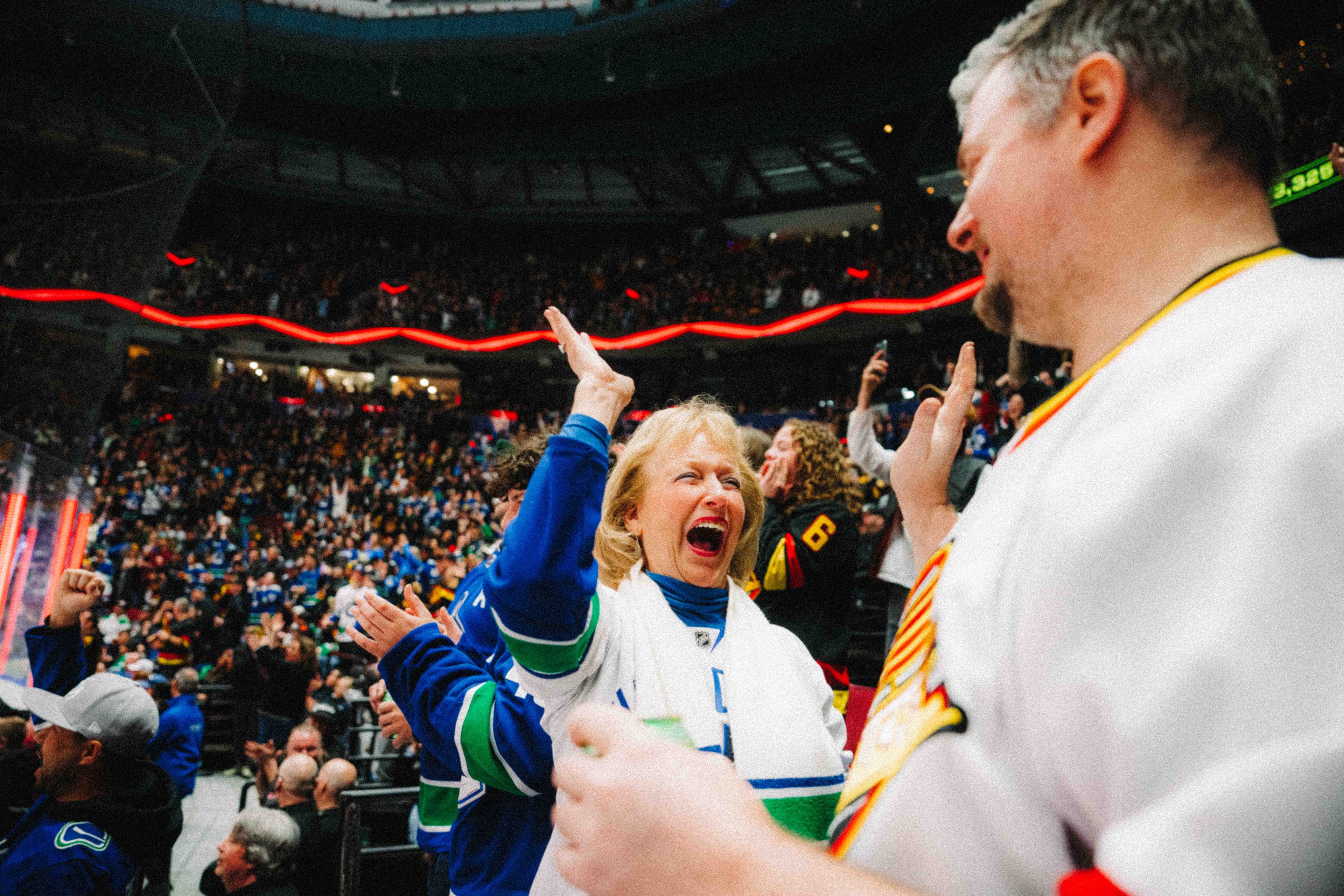Excited minor hockey group members watch the Vancouver Canucks from the stands.