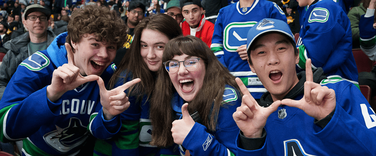 Excited Canucks fans cheering on the team.