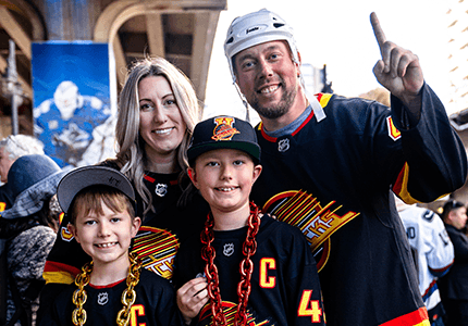 Excited minor hockey group members watch the Vancouver Canucks from the stands.